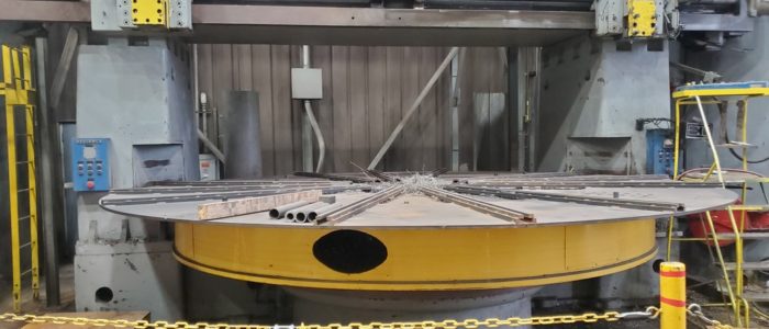Large circular component set up on a vertical boring mill in the Harris Thermal machine shop