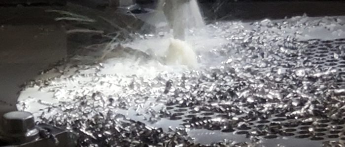 CNC machining of a heat exchanger tubesheet with coolant and metal chips