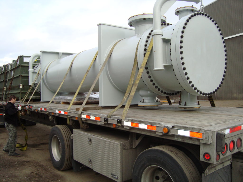 Coated shell and tube heat exchanger secured on a flatbed trailer for shipment