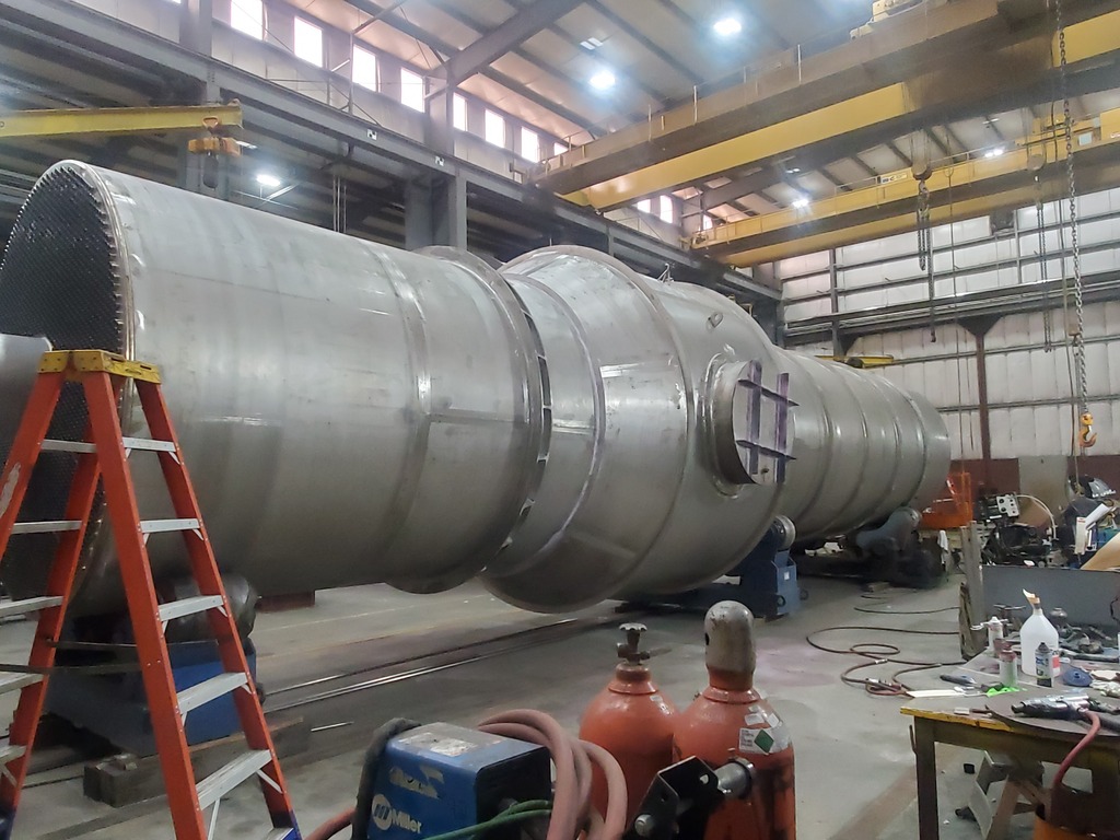 Large stainless steel shell and tube heat exchanger with exposed tubesheet in the Harris Thermal shop