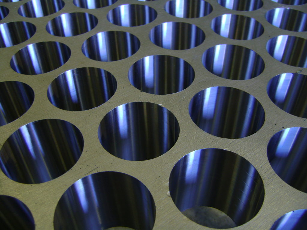 Close-up of precision-drilled holes in a heat exchanger tubesheet