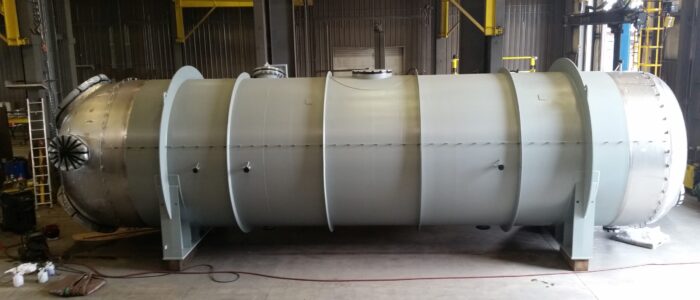 Gray-coated horizontal heat exchanger with stiffening rings in the Harris Thermal shop
